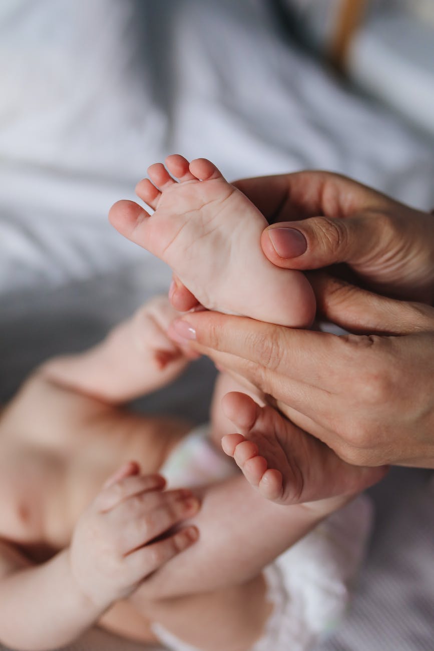 person holding baby s feet